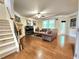 Comfortable living room with a fireplace, hardwood floors, and plenty of natural light at 827 Autry Oak Ct, Johns Creek, GA 30022