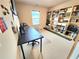 Inviting home office featuring a large desk, built-in shelving, and neutral carpet, perfect for work or study at 827 Autry Oak Ct, Johns Creek, GA 30022