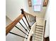 Carpeted stairway featuring a wooden handrail and decorative iron spindles at 827 Autry Oak Ct, Johns Creek, GA 30022
