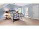 Bedroom featuring sky blue walls, a view to the ensuite bathroom, and a black metal bed frame at 1824 Mount Paran Nw Rd, Atlanta, GA 30327