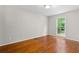 Bright bedroom with gleaming hardwood floors and a large window offering a peaceful view at 1824 Mount Paran Nw Rd, Atlanta, GA 30327