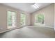 Bedroom featuring a vaulted ceiling, soft carpet, and plenty of natural light from multiple windows at 1824 Mount Paran Nw Rd, Atlanta, GA 30327