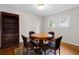 Cozy dining area with a round table, chairs, and natural light from the nearby windows at 1824 Mount Paran Nw Rd, Atlanta, GA 30327
