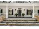 Charming front porch with stone steps, white columns, black shutters, and a welcoming entrance at 1824 Mount Paran Nw Rd, Atlanta, GA 30327