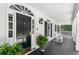 Spacious front porch with rocking chairs and elegant black door at 1824 Mount Paran Nw Rd, Atlanta, GA 30327