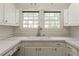 Bright kitchen sink area with white cabinets, a faucet, and a view to the outside yard at 1824 Mount Paran Nw Rd, Atlanta, GA 30327