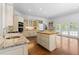 Bright kitchen with an island, granite counters, custom cabinets, and stainless-steel appliances at 1824 Mount Paran Nw Rd, Atlanta, GA 30327