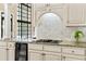 Kitchen featuring stone counters, custom cabinets, a wine fridge, and stainless-steel appliances at 1824 Mount Paran Nw Rd, Atlanta, GA 30327