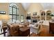 Bright living room featuring a stone fireplace, built-in shelving, and a large arched window at 1824 Mount Paran Nw Rd, Atlanta, GA 30327
