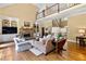 Spacious living room with a stone fireplace, hardwood floors, and a view of the upper-level balcony at 1824 Mount Paran Nw Rd, Atlanta, GA 30327