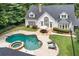 Backyard view showcasing a pristine pool, hot tub, and outdoor dining area at 1824 Mount Paran Nw Rd, Atlanta, GA 30327