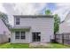 View of the back of the house with a siding exterior, small patio, and fenced yard at 3458 Carriage Chase Rd, Atlanta, GA 30349