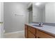 Bathroom with wood vanity, a sleek countertop, a frameless shower, and a large, well-lit mirror at 3458 Carriage Chase Rd, Atlanta, GA 30349