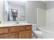 Bathroom with a wooden vanity, standard toilet, and a shower-tub combo at 3458 Carriage Chase Rd, Atlanta, GA 30349