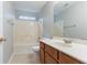 Bathroom with a shower-tub combo and wooden vanity is a functional and relaxing space at 3458 Carriage Chase Rd, Atlanta, GA 30349