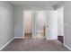 Carpeted bedroom with a walk-in closet and an adjacent bathroom provides comfort and convenience at 3458 Carriage Chase Rd, Atlanta, GA 30349