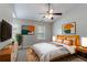 Bright bedroom featuring a ceiling fan, large windows, and stylish, modern decor at 3458 Carriage Chase Rd, Atlanta, GA 30349