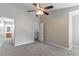 Spacious bedroom featuring neutral colors, carpeted flooring, and a ceiling fan at 3458 Carriage Chase Rd, Atlanta, GA 30349