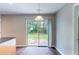 A sunlit dining area with sliding glass doors and wood flooring at 3458 Carriage Chase Rd, Atlanta, GA 30349