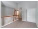 Upstairs hallway with neutral walls and carpeting offers a seamless transition between rooms at 3458 Carriage Chase Rd, Atlanta, GA 30349
