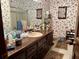 Bathroom with decorative wallpaper, single sink vanity, and floral accents at 115 Cannongate Cir, Sharpsburg, GA 30277