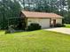 Detached garage surrounded by lush greenery with a well-manicured lawn at 115 Cannongate Cir, Sharpsburg, GA 30277