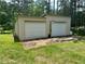 Detached outbuilding with two garage doors perfect for storage, workshop or hobby space at 115 Cannongate Cir, Sharpsburg, GA 30277