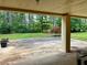 Large outdoor patio overlooking a spacious backyard with lush greenery and mature trees at 115 Cannongate Cir, Sharpsburg, GA 30277