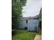 View of the back of the house from the overgrown backyard at 133 Buchanan Ln, Atlanta, GA 30315