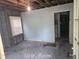 A distressed living room featuring peeling paint and damaged floors, awaiting renovation at 133 Buchanan Ln, Atlanta, GA 30315
