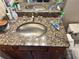 Close-up of a bathroom sink with granite countertop and brushed nickel faucet at 2479 Peachtree Ne Rd # 1714, Atlanta, GA 30305