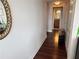 Neutral colored walls lead to the bathroom and a dark hardwood floor and mirror accent the hall at 2479 Peachtree Ne Rd # 1714, Atlanta, GA 30305