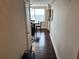 A hallway with hardwood floors leads to a dining area with a table, chairs, and a window at 2479 Peachtree Ne Rd # 1714, Atlanta, GA 30305