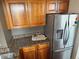 A kitchen features wood cabinets, stainless steel refrigerator, and granite countertops at 2479 Peachtree Ne Rd # 1714, Atlanta, GA 30305