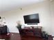 A modern living room featuring a large television, entertainment center, and sleek hardwood floors at 2479 Peachtree Ne Rd # 1714, Atlanta, GA 30305