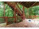 Outdoor deck features red wood, a swing, stair access to the yard and view of the surrounding trees at 2693 Blairsden Nw Pl, Kennesaw, GA 30144