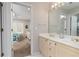 Bathroom with double vanity sinks, large mirror, and view into adjacent bedroom at 2693 Blairsden Nw Pl, Kennesaw, GA 30144
