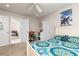 Well lit bedroom with tan carpeting, white paneled doors, a desk, and ceiling fan at 2693 Blairsden Nw Pl, Kennesaw, GA 30144