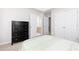 Light, bright bedroom with view to bathroom featuring a tall, dark dresser at 2693 Blairsden Nw Pl, Kennesaw, GA 30144