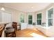 Sun-filled breakfast nook with hardwood floors, built-in seating, and large windows overlooking a backyard at 2693 Blairsden Nw Pl, Kennesaw, GA 30144