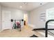 Brightly lit home gym with weight set, and an open door to what looks like an on-suite bath at 2693 Blairsden Nw Pl, Kennesaw, GA 30144