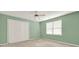 Freshly painted bedroom offers neutral carpet, a large window, and a ceiling fan at 4313 Deep Springs Nw Ct, Kennesaw, GA 30144