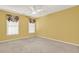 Bright bedroom with carpet, two windows, and ceiling fan at 4313 Deep Springs Nw Ct, Kennesaw, GA 30144