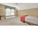 Comfortable bedroom features built-in bookshelves, window seating, and neutral carpet at 4313 Deep Springs Nw Ct, Kennesaw, GA 30144