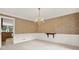 Elegant dining room with chandelier and wainscoting, perfect for hosting dinner parties at 4313 Deep Springs Nw Ct, Kennesaw, GA 30144