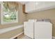 Bright laundry room with convenient washer and dryer, plus storage, and a backyard view at 4313 Deep Springs Nw Ct, Kennesaw, GA 30144