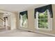 Spacious living room with large windows and elegant blue drapery at 4313 Deep Springs Nw Ct, Kennesaw, GA 30144