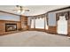 Cozy living room featuring a brick fireplace, built-in shelves, and large windows at 4313 Deep Springs Nw Ct, Kennesaw, GA 30144