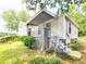 Side view of a bright, one-story home featuring a covered front porch and well-maintained lawn at 571 Grant Sw St, Atlanta, GA 30315