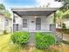 Charming one-story home with covered porch, wrought iron railing, and neatly manicured landscaping at 571 Grant Sw St, Atlanta, GA 30315